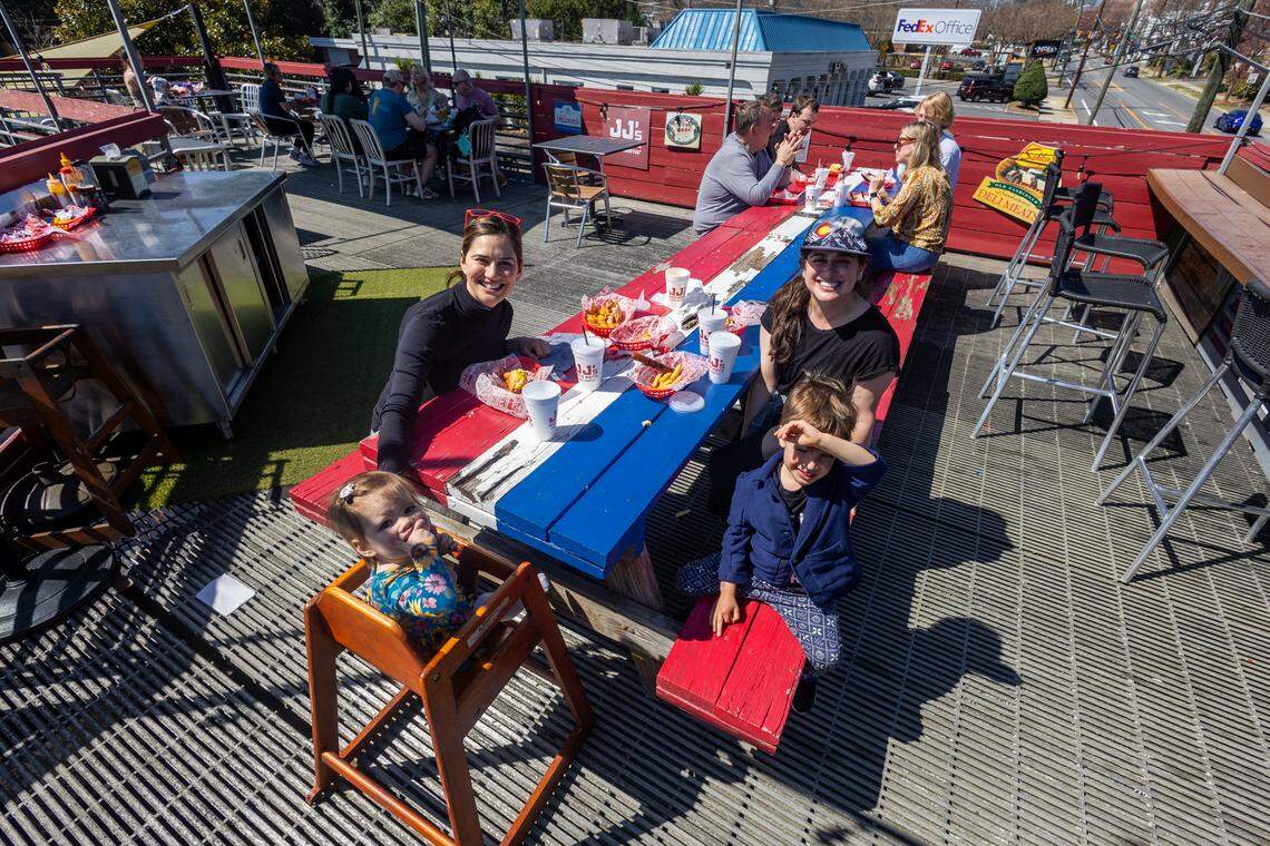 Nina Rose and her extended family on the patio at JJ’s Red Hots on Wednesday, March 12, 2025. The restaurant will close on Sunday, March 16, after almost 13 years.