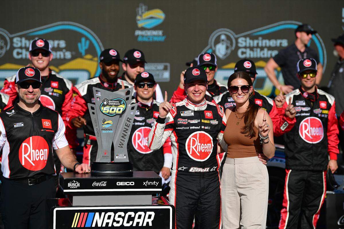 Christopher Bell poses for photos following his NASCAR Cup Series victory of the Shriners Childrens 500 at Phoenix Raceway in Avondale, Ariz., on March 10, 2024.