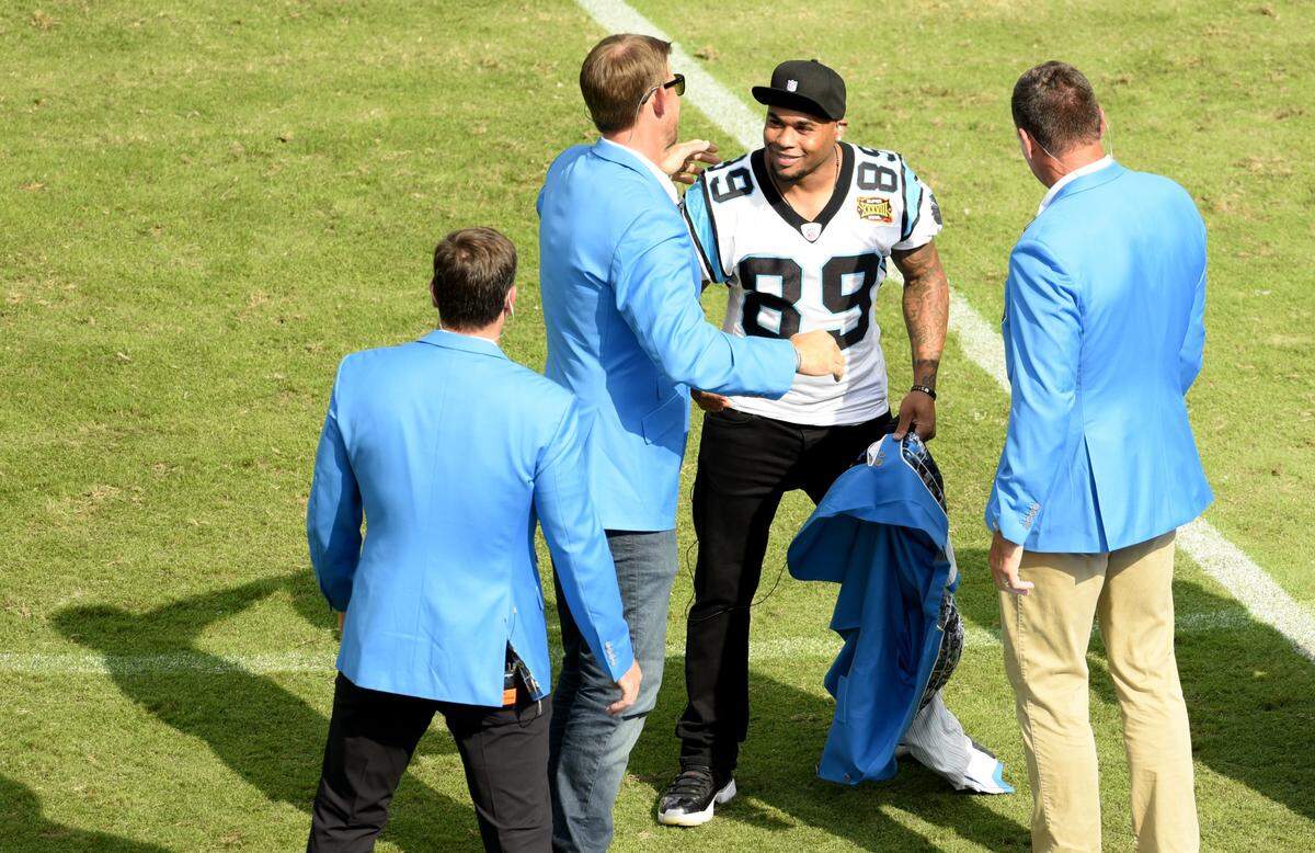 Steve Smith smiles after taking off his Panthers blue blazer to reveal his No. 89 jersey underneath during Carolina’s Hall of Honor ceremony in October. Smith was inducted along with Jake Delhomme, the quarterback he said he “grew up with” as a Panther.