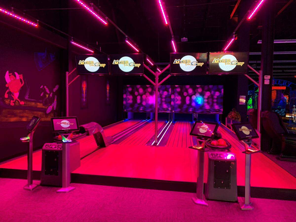 A glow in the dark bowling alley at one of Monster Mini Golf’s Charlotte area locations