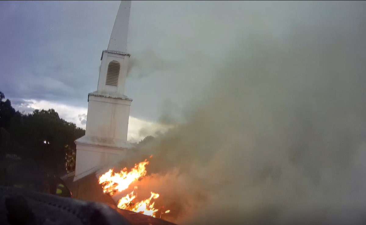 Fire burns on the roof of Kittie Sanson Chapel on the campus of Barber-Scotia College in Concord, NC, after a fire on Thursday, June 17, 2022.