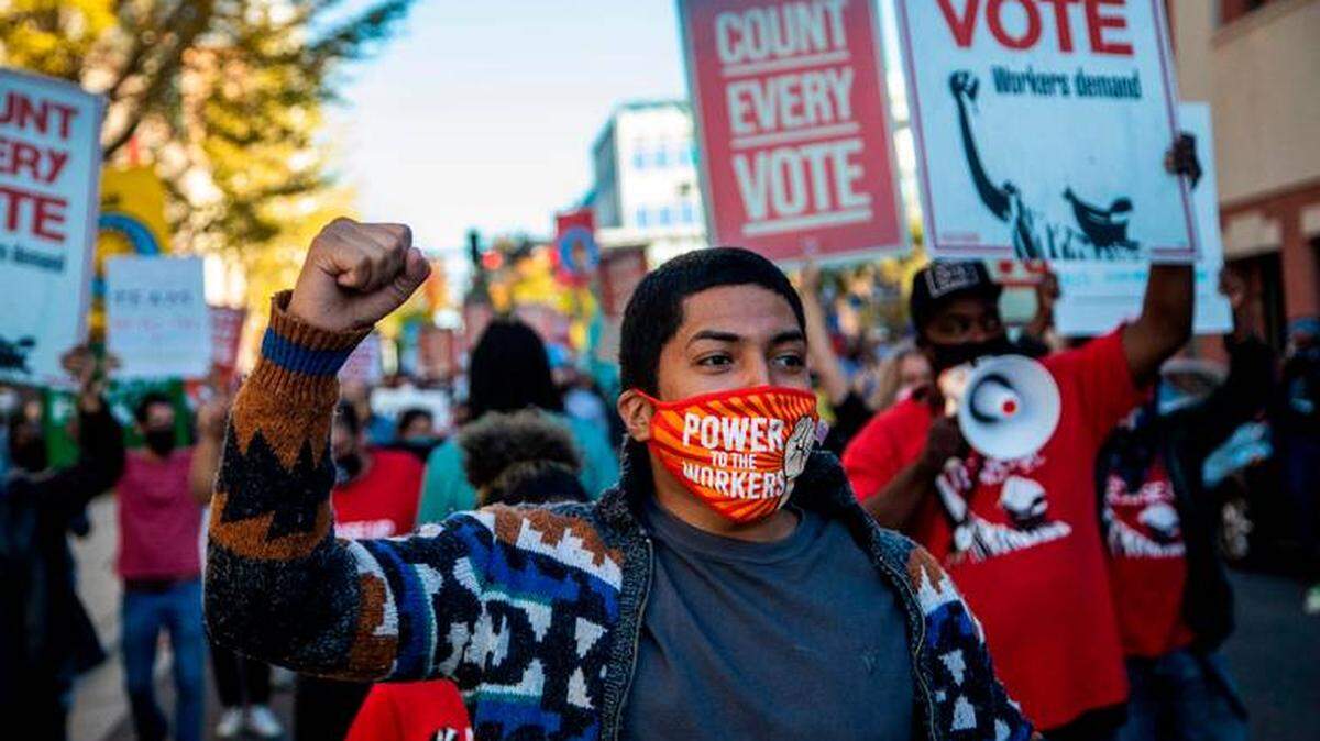 Demonstrators from several community and advocacy groups marched in downtown Durham Wednesday demanding that all votes cast in the 2020 election be counted.