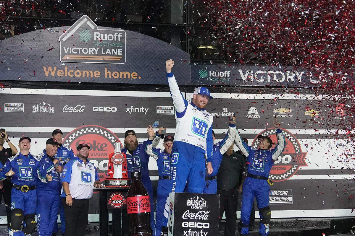 Aug 25, 2023; Daytona Beach, Florida, USA; NASCAR Cup Series driver Chris Buescher (17) celebrates in Victory Lane after winning the Coke Zero Sugar 400 at Daytona International Speedway. Mandatory Credit: David Yeazell-USA TODAY Sports
