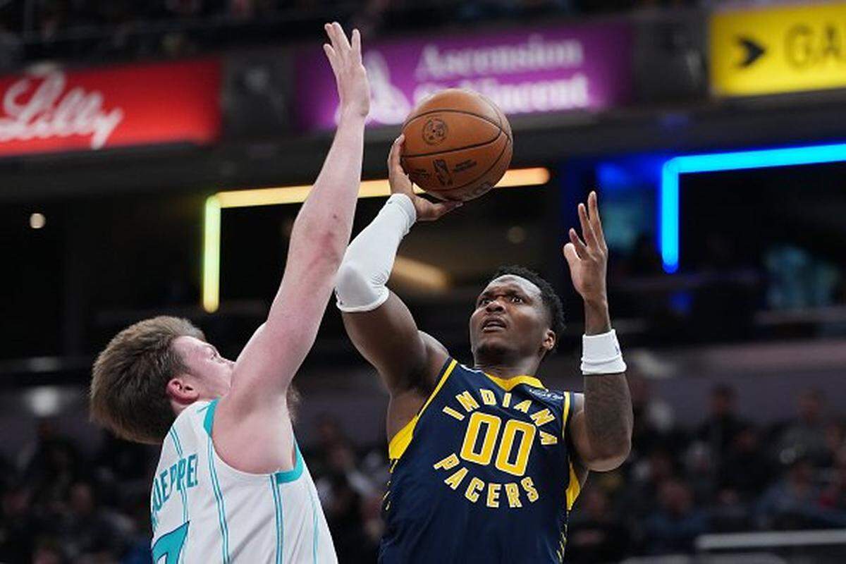 Bennedict Mathurin of the Indiana Pacers attempts a shot against Kon Knueppel of the Charlotte Hornets in the second quarter at Gainbridge Fieldhouse on Nov. 19, 2025, in Indianapolis, Indiana.