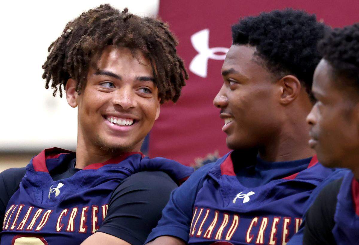 Mallard Creek Mavericks quarterback Perry Justice, left, enjoys a laugh with linebacker Deuce Midgett, right, during the Mecklenburg County Power 6 media day on Tuesday, August 5, 2025 at Independence High School.
