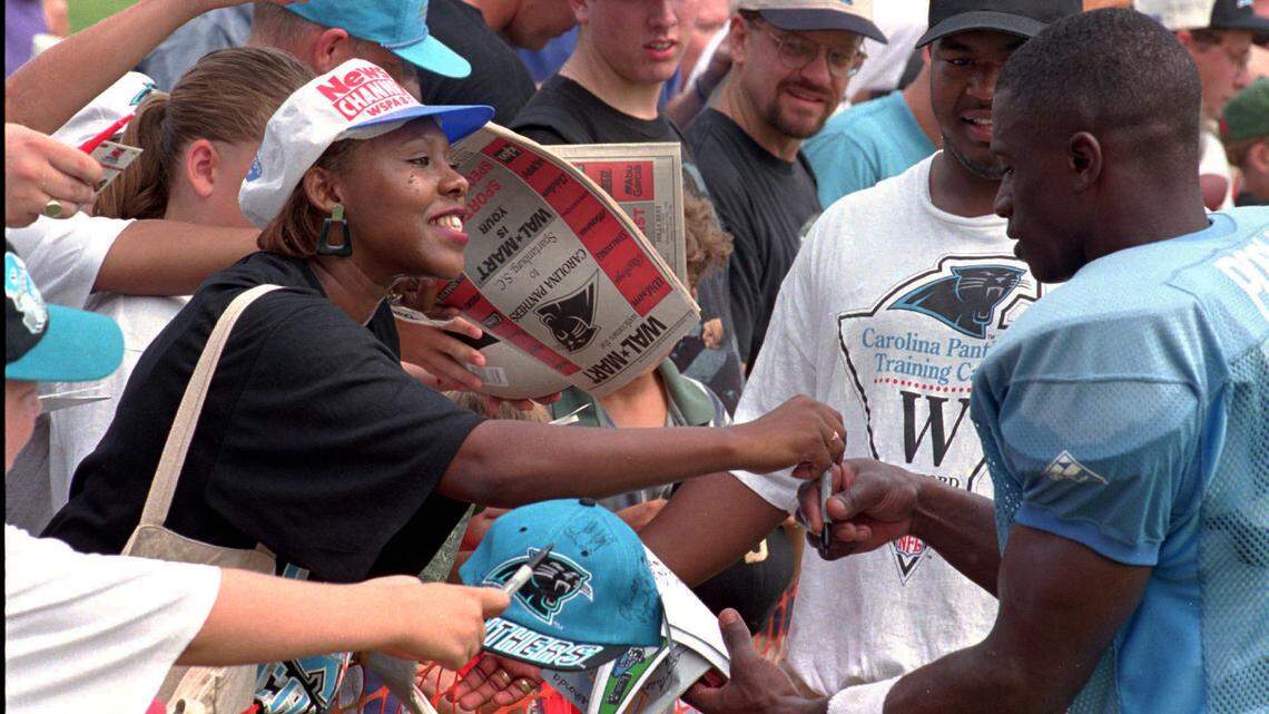  7/22/95 Kathy Gibson gets an autograph from cornerback Tyrone Poole on Friday. She got his attention by yelling “Tyrone Poole! Tyrone Poole!” and explaining she was a teacher.   