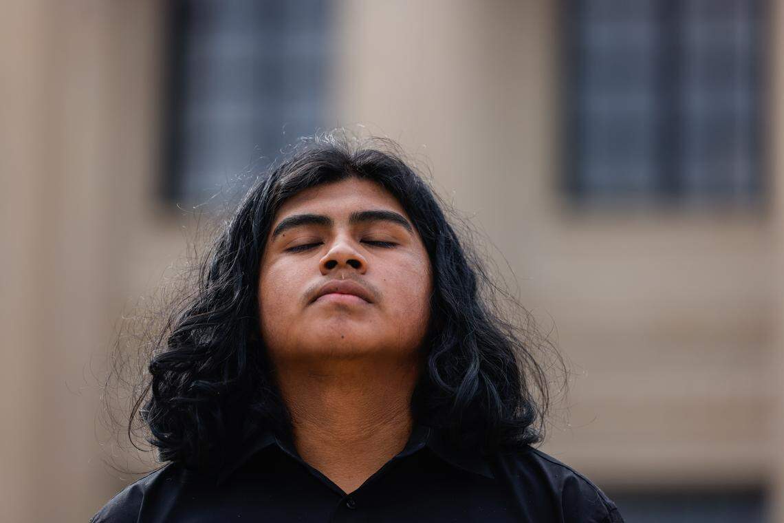 Brayan Vicente Martinez takes a moment during a protest Thursday outside the federal courthouse before the hearing for his brother, Miguel Martinez, who was detained by U.S. Border Patrol in Charlotte.