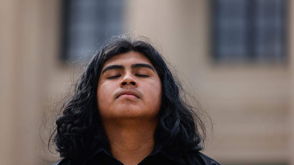 Brayan Vicente Martinez takes a moment during a protest outside the Federal Courthouse before the hearing for his brother, Miguel Martinez, who was detained by Customs and Border Patrol earlier this week in Charlotte on Thursday, November 20, 2025.