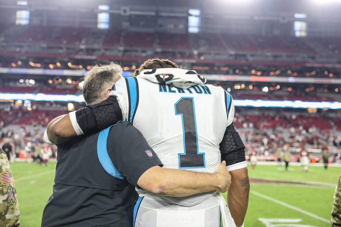 Carolina Panthers coach Matt Rhule, left, walks with Cam Newton after Sunday’s win against the Arizona Cardinals at State Farm Stadium in Glendale, Ariz., on Sunday. The Panthers defeated the Cardinals 34-10.