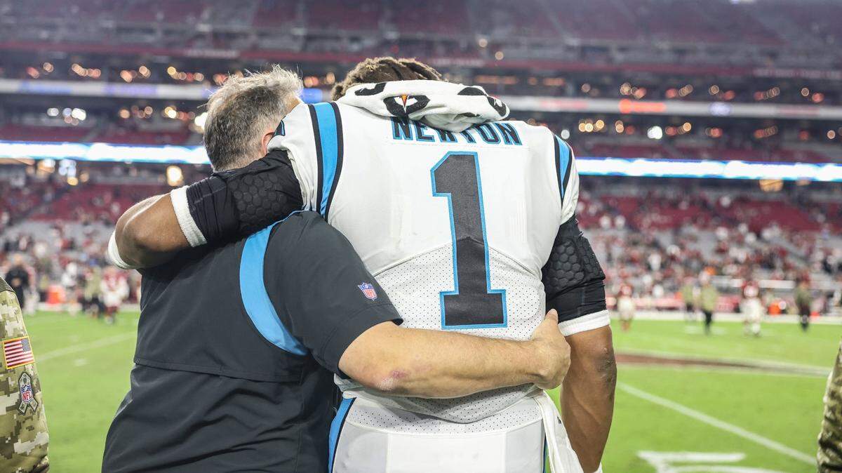 Carolina Panthers coach Matt Rhule, left, walks with Cam Newton after a win against the Arizona Cardinals at the State Farm Stadium in Glendale AZ, on Sunday, November 14, 2021. The Panthers defeated the Cardinals 34-10.