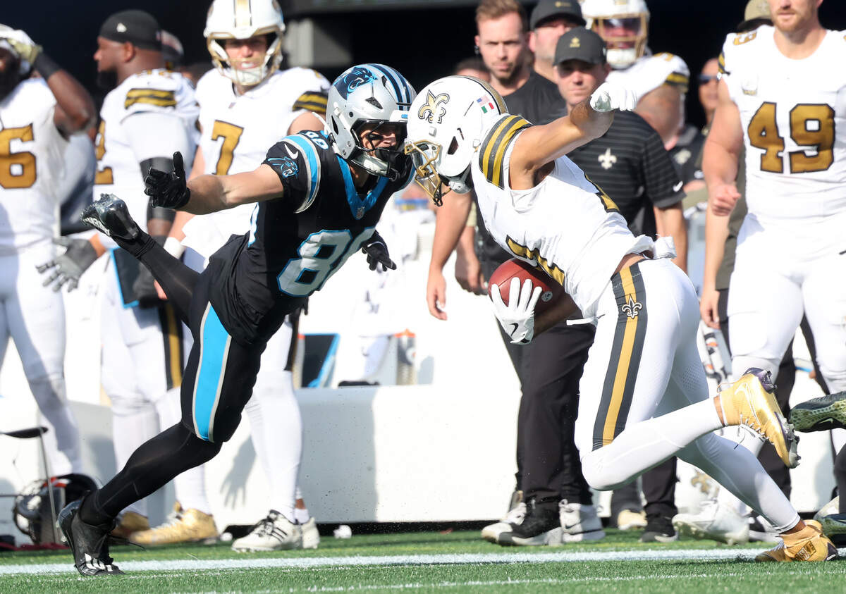 Carolina Panthers Nate Schmidt lunges towards New Orleans Saints Dante Pettis Sunday, Nov. 9, 2025 at Bank of America Stadium in Charlotte.