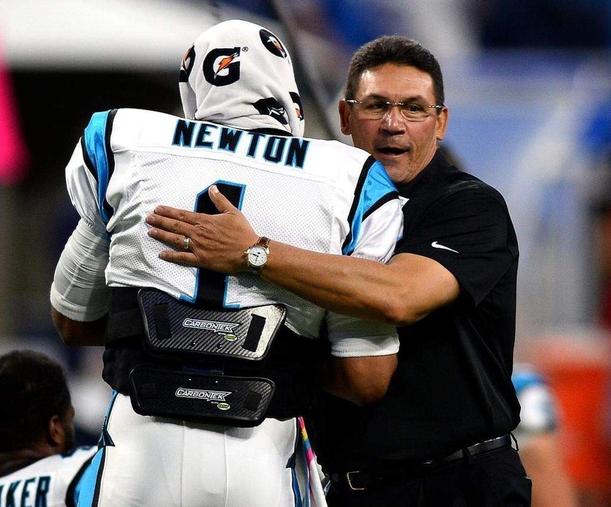 Carolina Panthers head coach Ron Rivera, right, embraces quarterback Cam Newton, left, before a game.