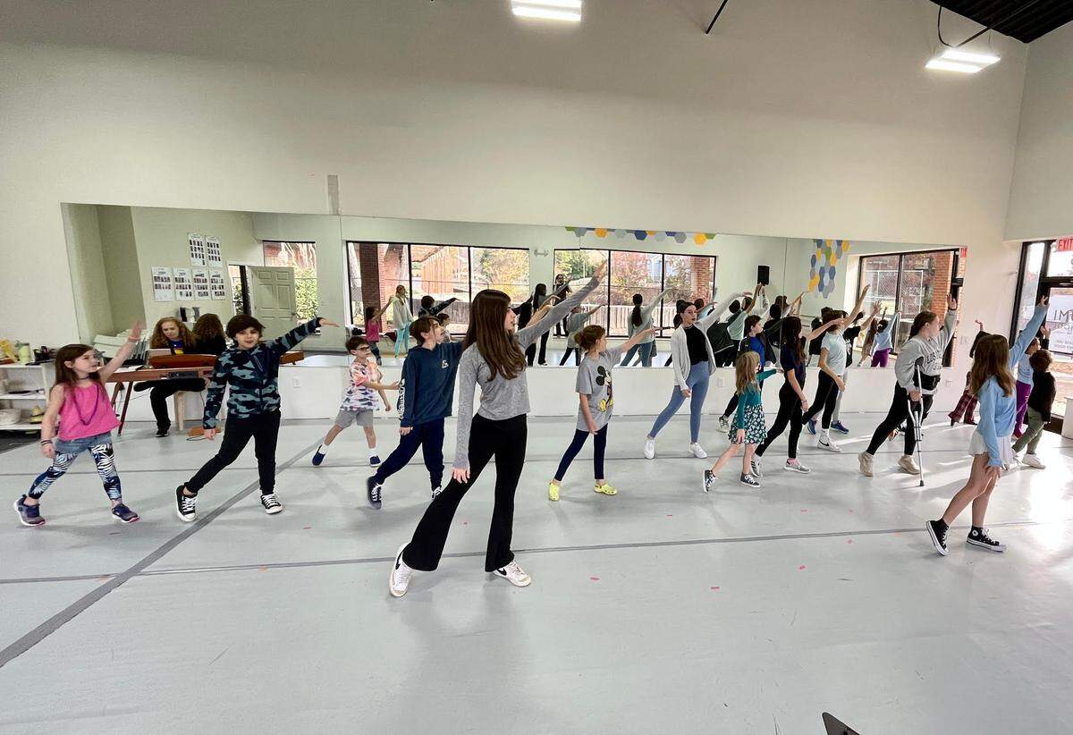 The youth cast of “Godspell” goes through rehearsal for their upcoming performance.