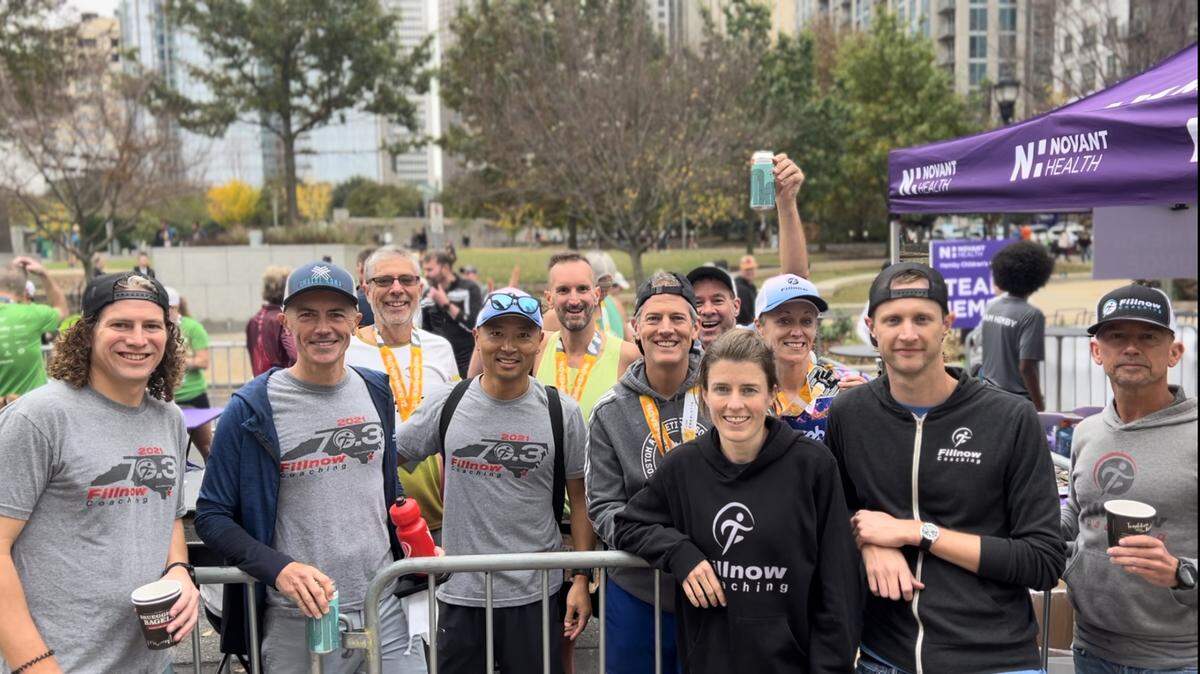 Théoden Janes, center, with friends at the finish line area of the Charlotte Marathon in November of 2022.