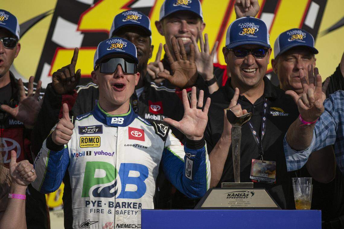 Sep 9, 2023; Kansas City, Kansas, USA; NASCAR Xfinity Series driver John Hunter Nemechek (20) poses with the trophy after winning the Xfinity Series Kansas Lottery 300 at Kansas Speedway. Mandatory Credit: Amy Kontras-USA TODAY Sports