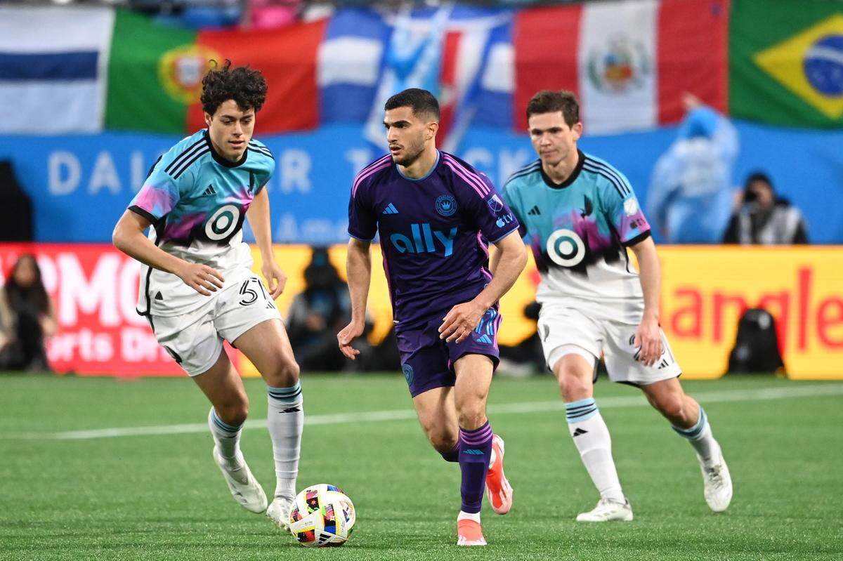 Minnesota United midfielder Caden Clark (37) and Charlotte FC forward Liel Abada (11) battle for the ball Sunday at Bank of America Stadium.