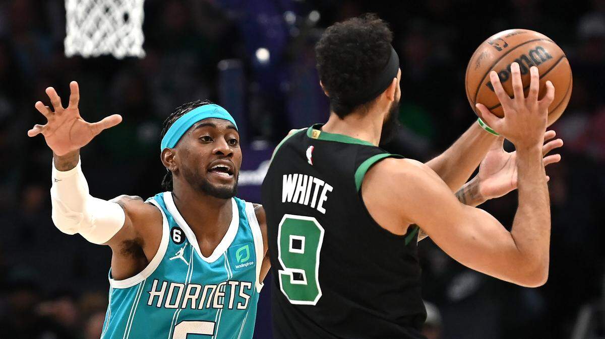 Charlotte Hornets forward Jalen McDaniels, left, applies defensive pressure on Boston Celtics guard Derrick White, right, during first half action at Spectrum Center in Charlotte, NC on Monday, January 16, 2023.
