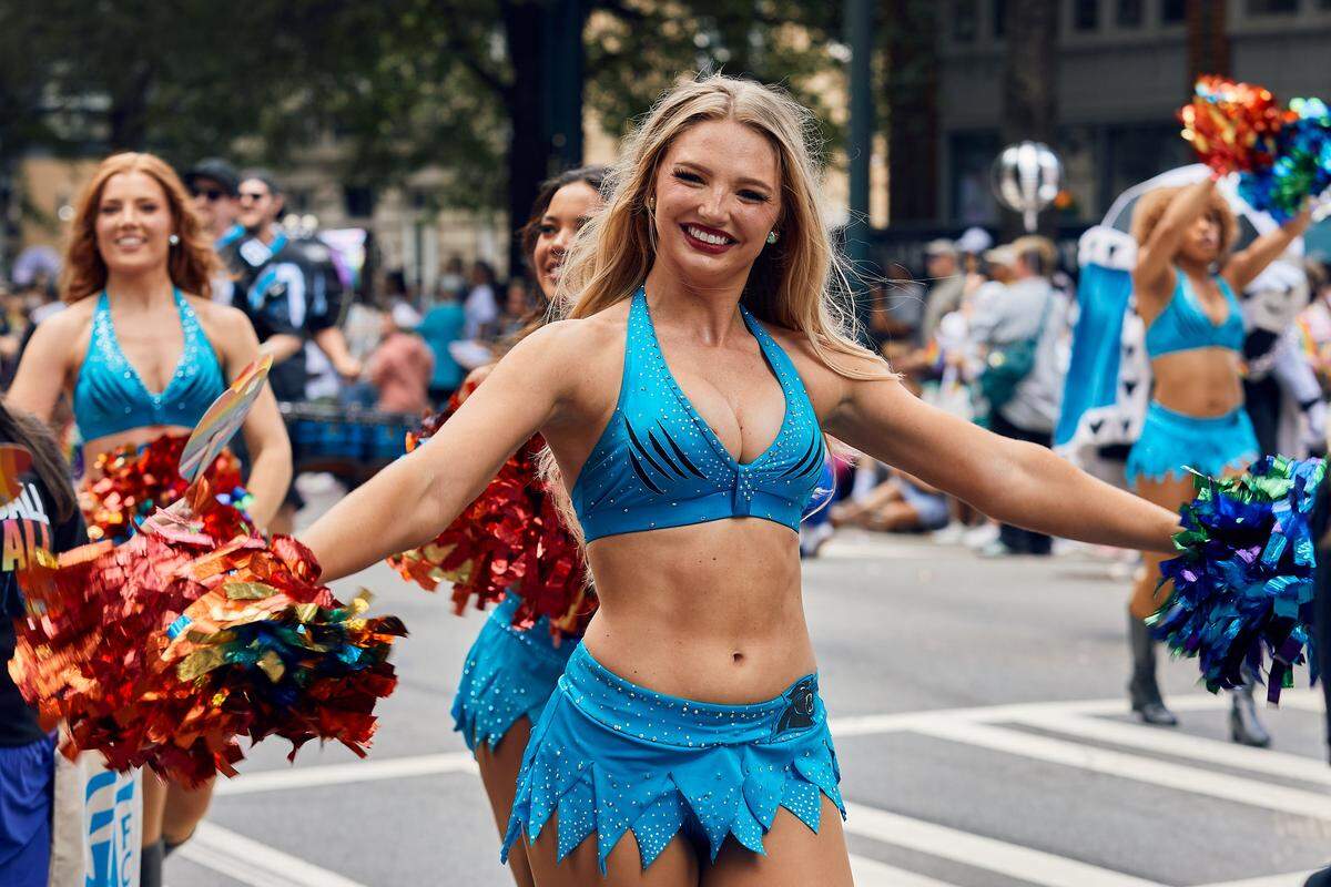 The Charlotte Panther’s Cheerleaders make their way through the parade route during the 25th Charlotte Pride Parade in uptown Charlotte on August 17, 2025.