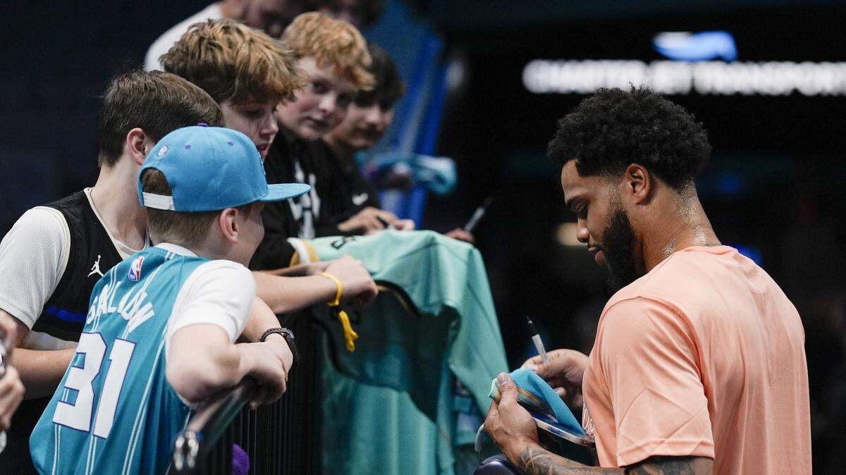 Charlotte Hornets forward Miles Bridges (0) signs autographs during pregame warm ups against the Milwaukee Bucks at Spectrum Center.