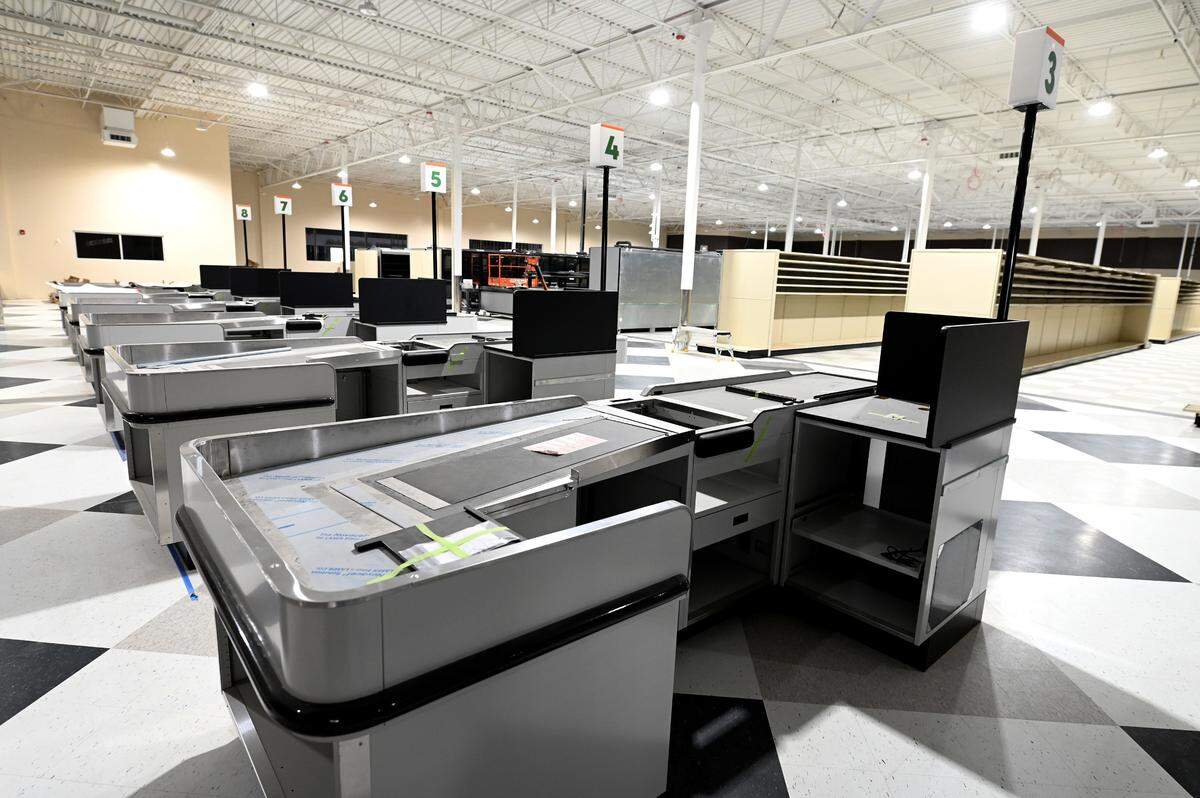 The interior of the new Super G Mart in Pineville is still being finished with check-out lanes and shelving, shown April 20.