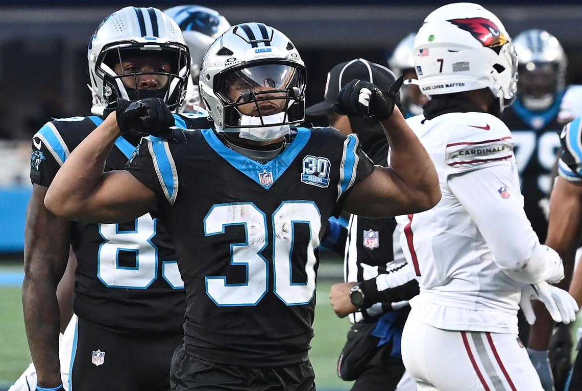 Carolina Panthers running back Chuba Hubbard flexes his arms after rushing for yardage against the Arizona Cardinals during overtime at Bank of America Stadium in Charlotte, NC on Sunday, December 22, 2024. Hubbard rushed for the game winning touchdown to give the Panthers a 36-30 victory over the Cardinals.