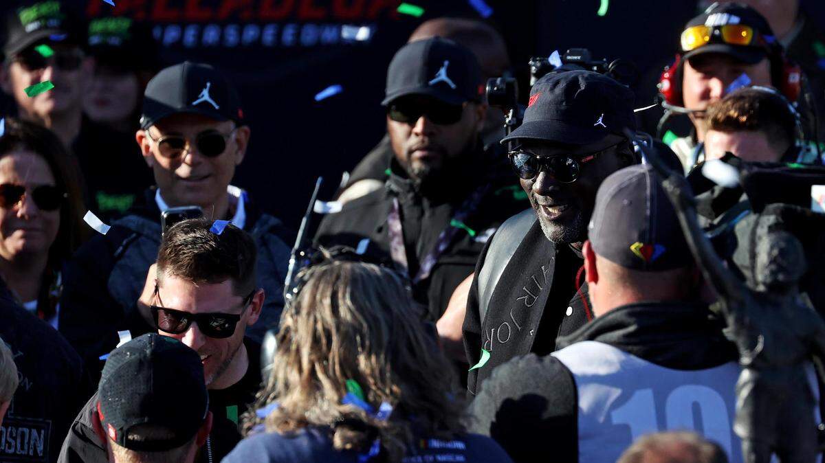 23XI Racing owners Denny Hamlin and Michael Jordan congratulate driver Tyler Reddick (45) after he won the NASCAR Cup Series’ GEICO 500 at Talladega Superspeedway.