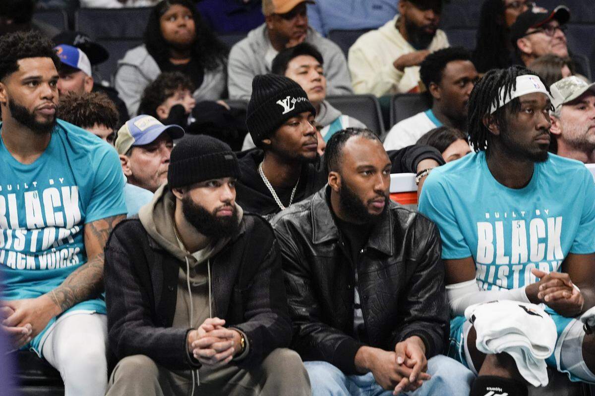 Feb 3, 2025; Charlotte, North Carolina, USA; Charlotte Hornets forward Miles Bridges (0), forward Cody Martin (11), forward Brandon Miller (24), forward Josh Okogie (12) and center Mark Williams (5) watch from the bench during the first half against the Washington Wizards at Spectrum Center. Mandatory Credit: Jim Dedmon-Imagn Images