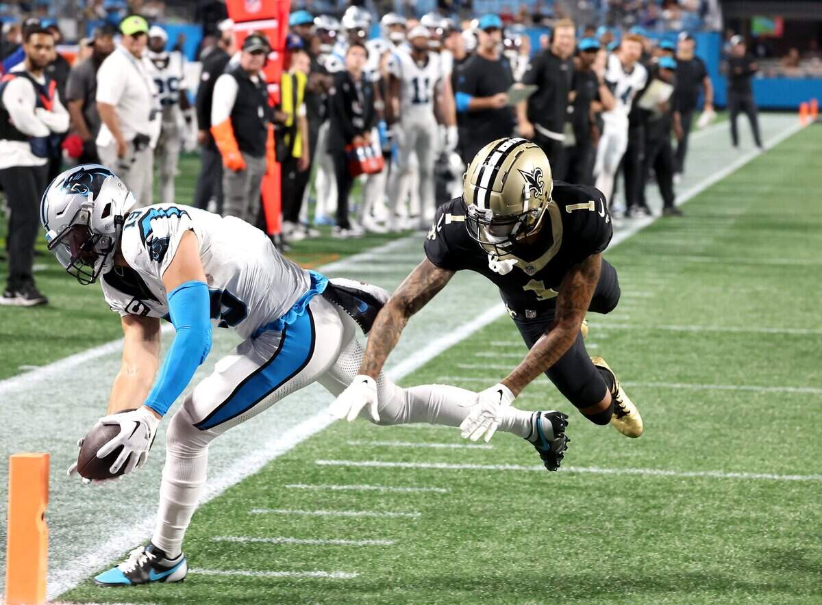 Carolina Panthers wide receiver Adam Thielen, left, stretches the ball out toward the pylon to score a touchdown against New Orleans. Thielen has scored in each of the Panthers’ last two games.