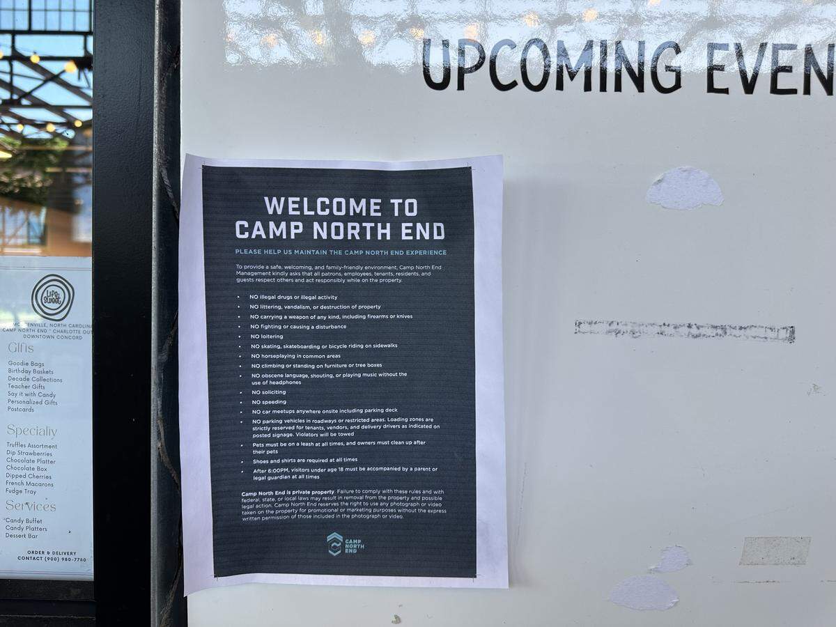 Signs posted around Camp North End list the rules of the shopping area, including the 6 p.m. curfew for anyone under 18 not with an adult.