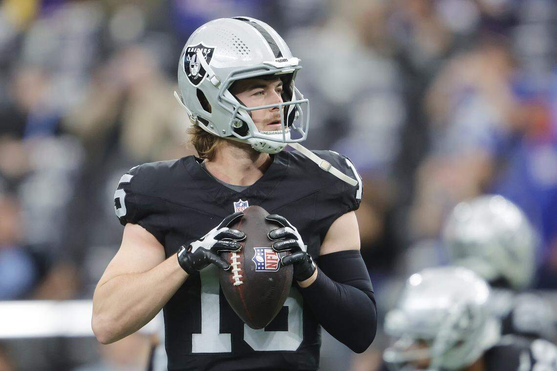 Las Vegas Raiders quarterback Kenny Pickett warms up ahead of a 2025 game.