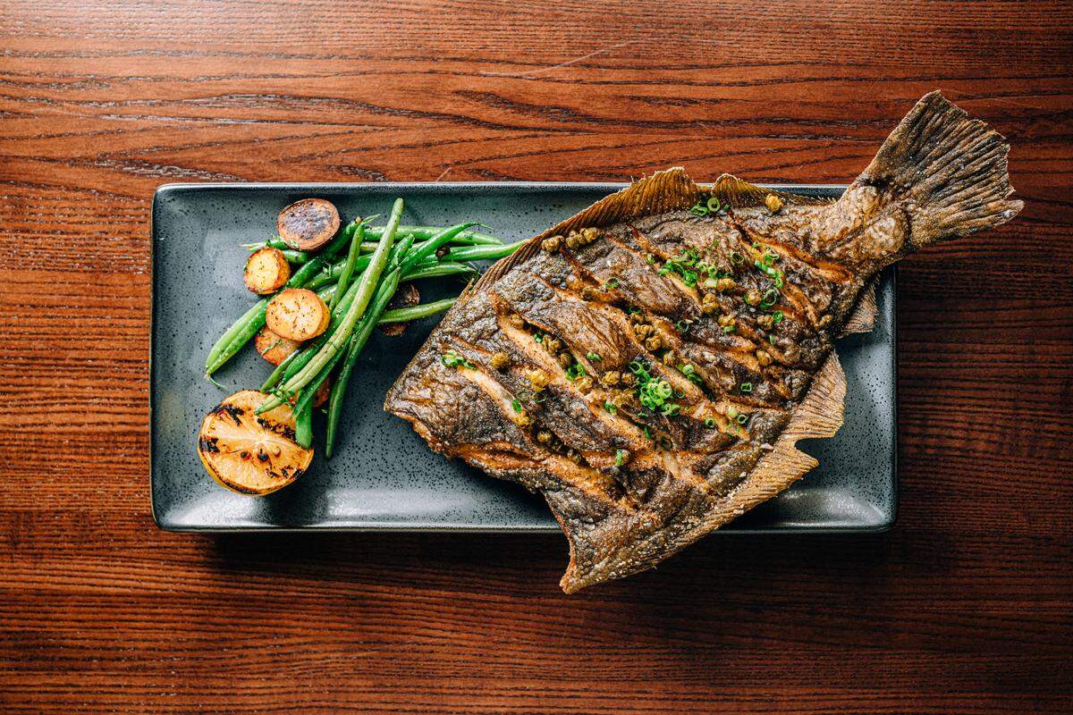A crispy flounder is one of many seafood dishes, like sea scallops and lobster roll, at Link & Pin, which opened a second location in Huntersville. The first location opened last November in South Park. 