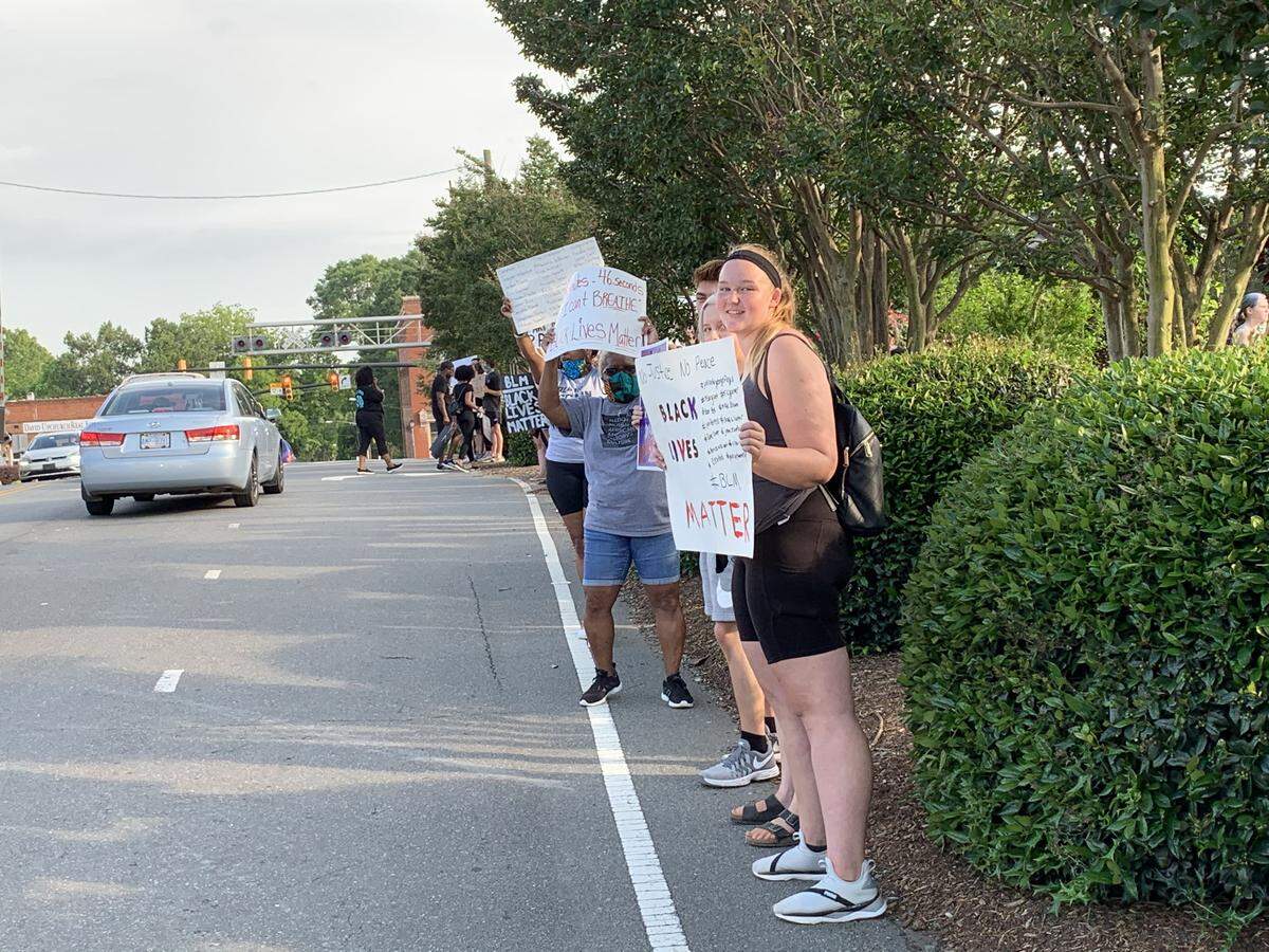 Protesters line South Broome Street on Thursday evening in Waxhaw.