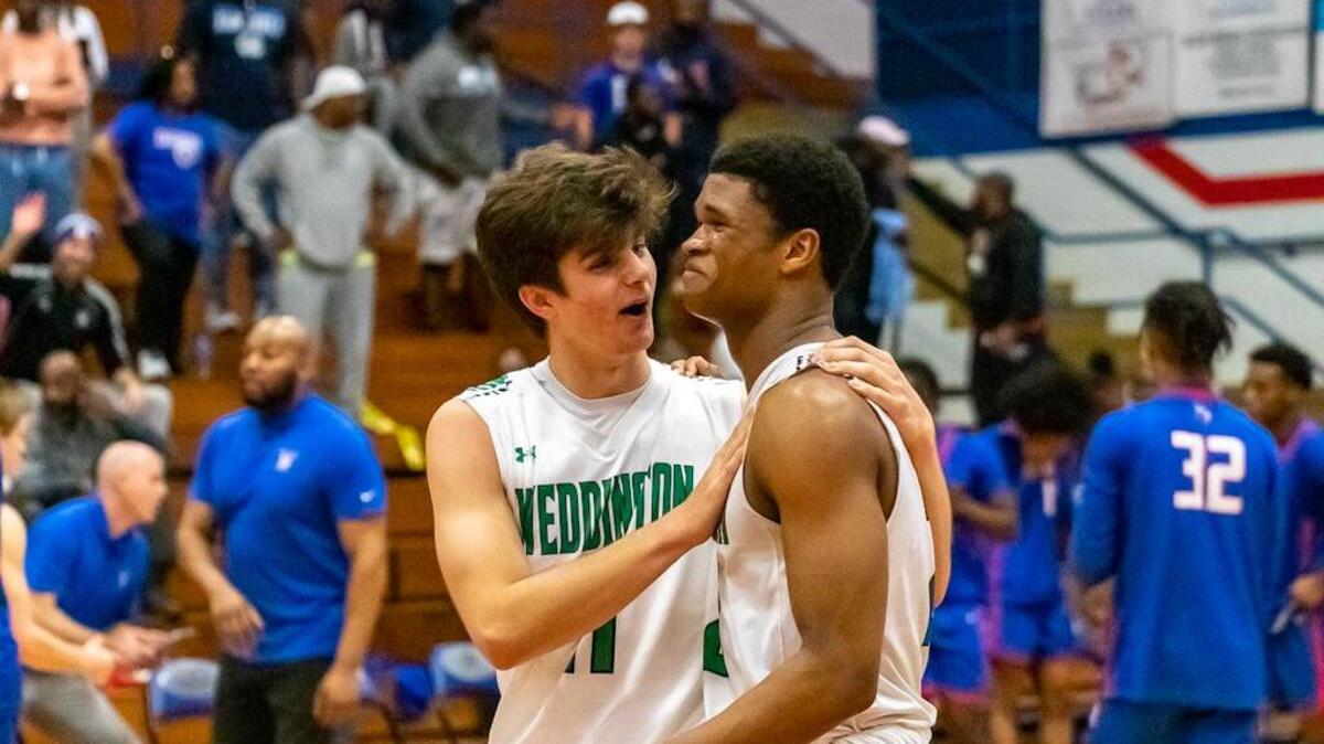 Weddington players Chase Lowe and Nolan Dunphy embrace them in an emotion hug after their win over North Meck