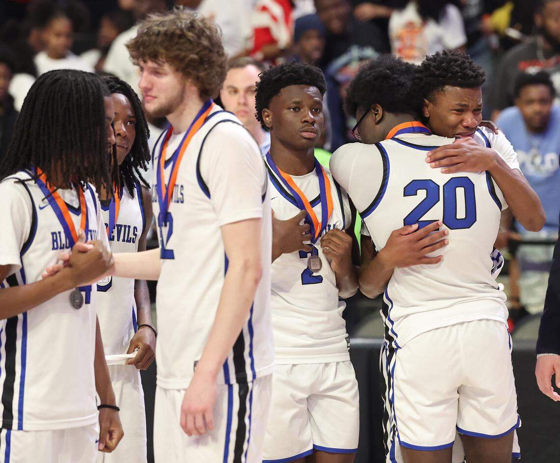 Members of the Mooresville boys’ basketball team console one another following the team’s loss to Southern Durham in the 7A championship game on Saturday in Winston-Salem.
