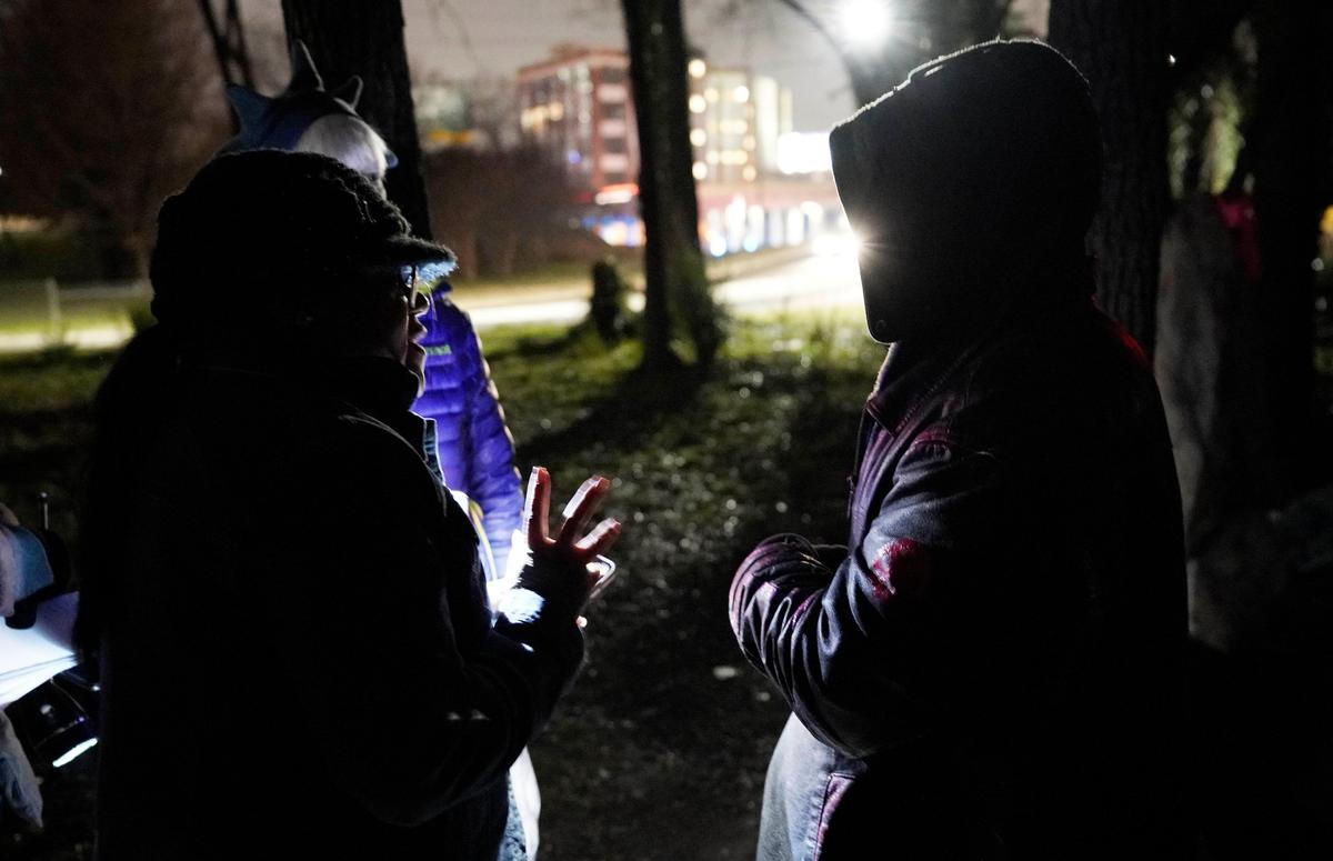 Homeless advocate Juaniska Davis, left, and Sharon McCarthy interview a homeless person during the annual ‘point in time’ canvas of the homeless near uptown Charlotte on Thursday, January 30, 2020.
