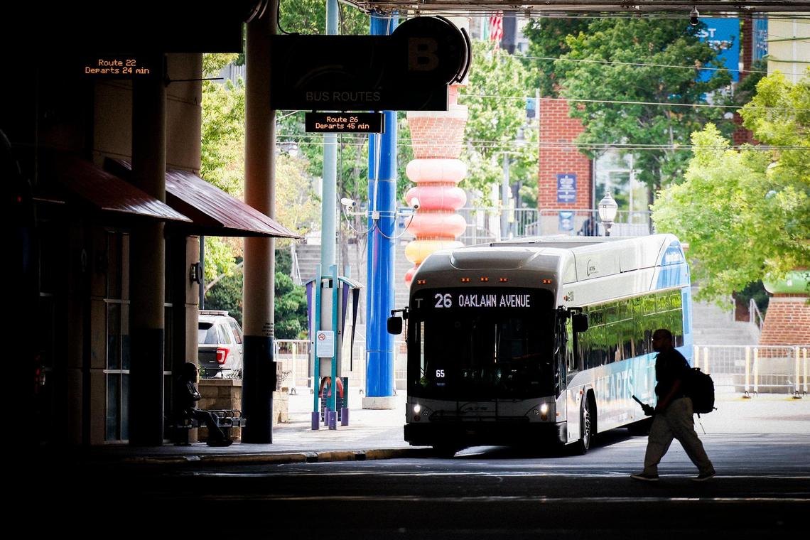 People make their way to busses at the Charlotte Transportation Center in Charlotte, N.C., Tuesday, July 12, 2022.