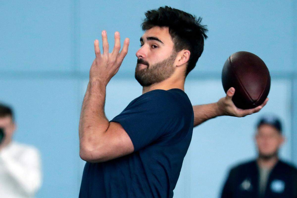 North Carolina quarterback Sam Howell demonstates his skills for NFL scouts during Pro Day, Monday, March 28, 2022, in Chapel Hill, N.C. (AP Photo/Chris Seward)