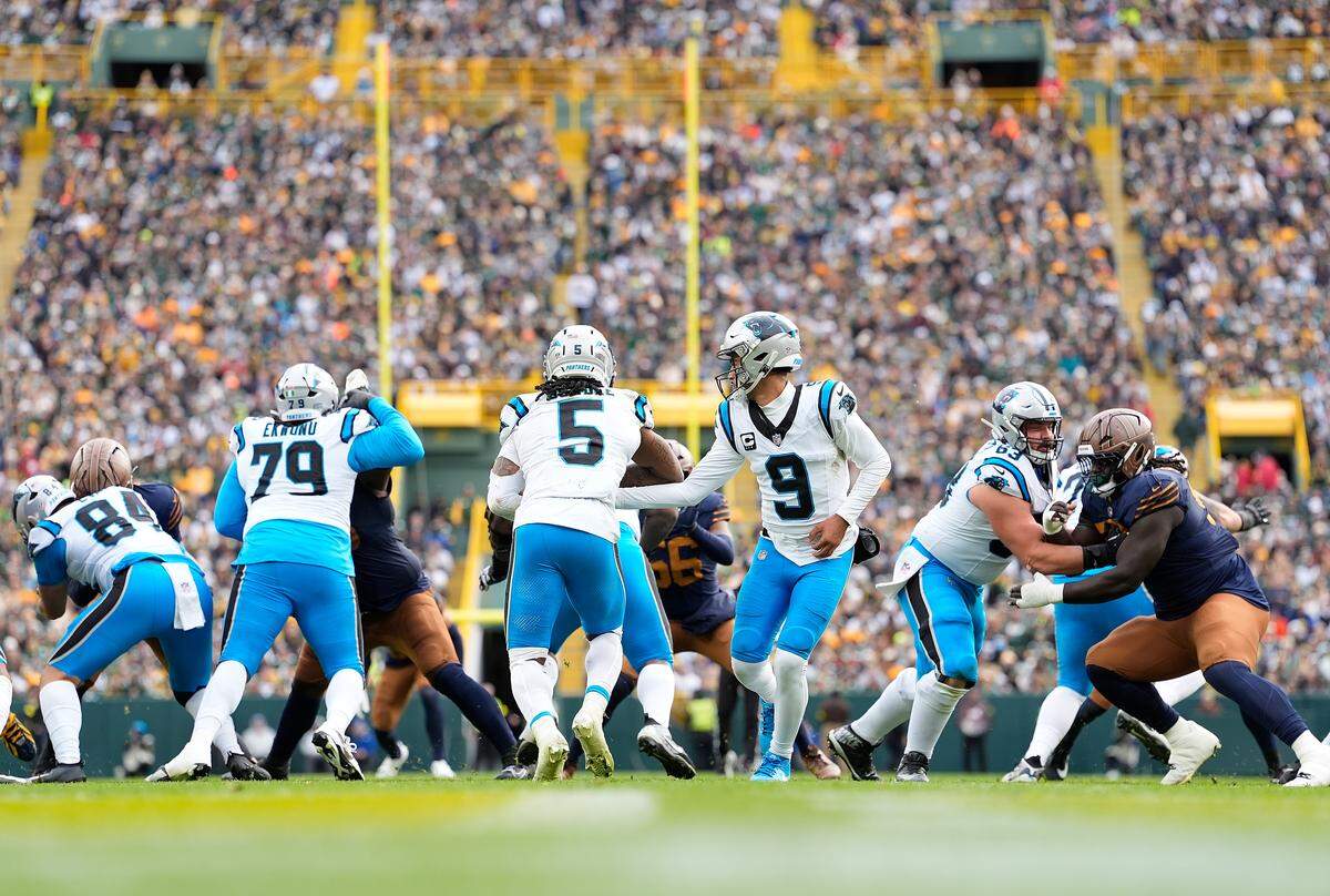 Carolina Panthers quarterback Bryce Young hands the ball off to Rico Dowdle during Sunday’s game against the Green Bay Packers at Lambeau Field.