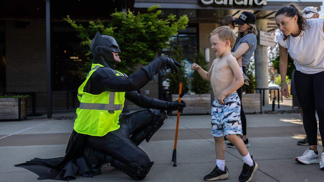 The Batman of Charlotte, D.J. Jones, greets, Everet Whelan, 5, on Saturday, April 18. 
