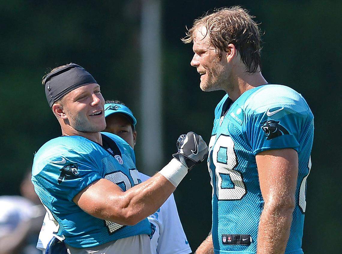 Carolina Panthers tight end Greg Olsen, right, jokes with running back Christian McCaffrey in 2019 when the two were teammates.