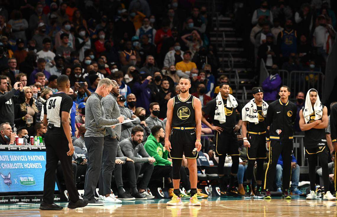 Golden State Warriors guard Steph Curry (center) had 24 points and 10 assists in Charlotte Sunday night, but his team lost, 106-102, to the Hornets. It was only Golden State’s second loss of the NBA season.