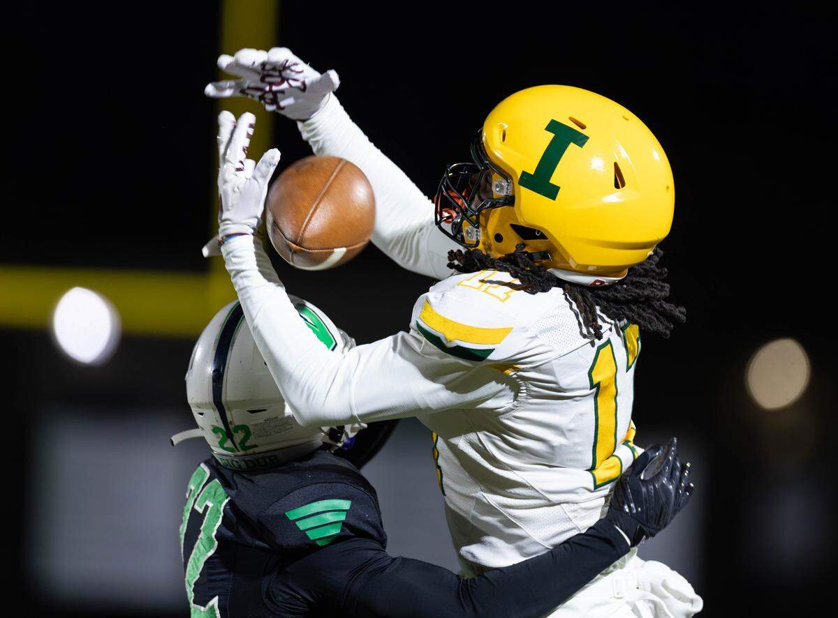 Weddington's Ace Clements (left) knocks the ball loose at the last minute from the Patriot's wide receiver King Rhodes II (right). Weddington would host Independence in the NCHSAA quarterfinal playoff game Friday, November, 28 2025.
