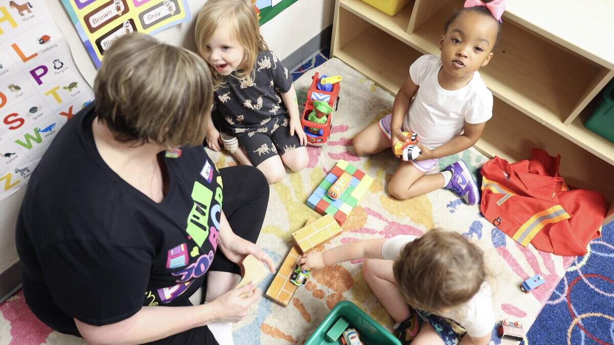 Emma Biggs, left, director of Pathway Preschool Center in Charlotte, plays with children at the center on Friday, May 22, 2026.