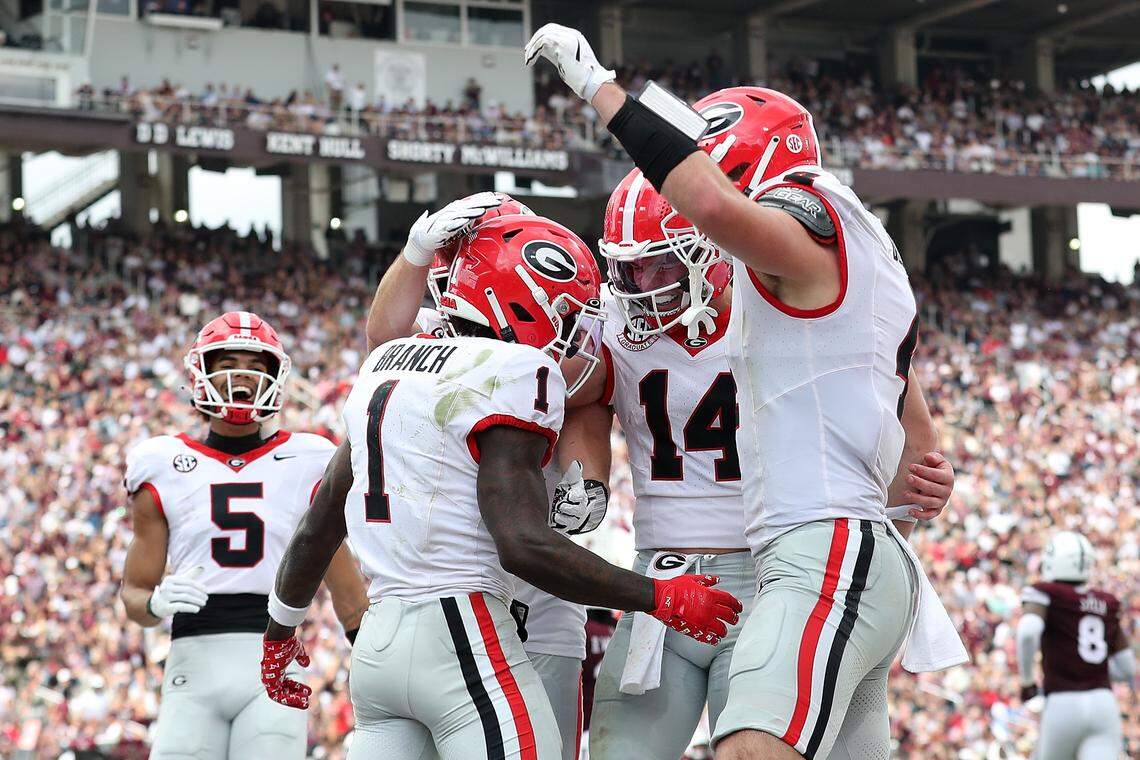 Gunner Stockton (14) of the Georgia Bulldogs and teammate Zachariah Branch (1) after a touchdown during the first half against the Mississippi State Bulldogs on Nov. 8, 2025, at Davis Wade Stadium in Starkville, Miss.