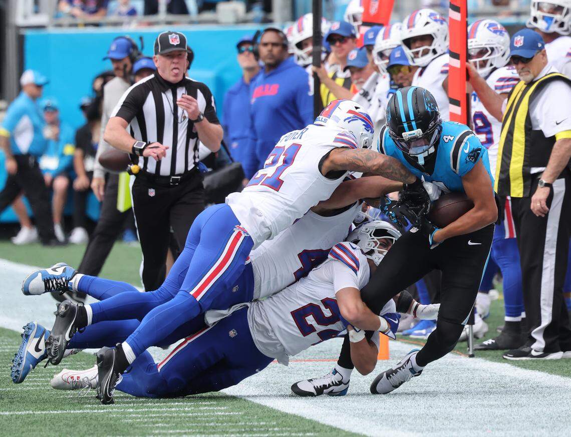 Carolina’s Tetairoa McMillan is brought down by Buffalo’s Cole Bishop (24) and Dorian Williams (44) as Jordan Poyer runs nearby on Oct. 26, 2025, in Charlotte. 