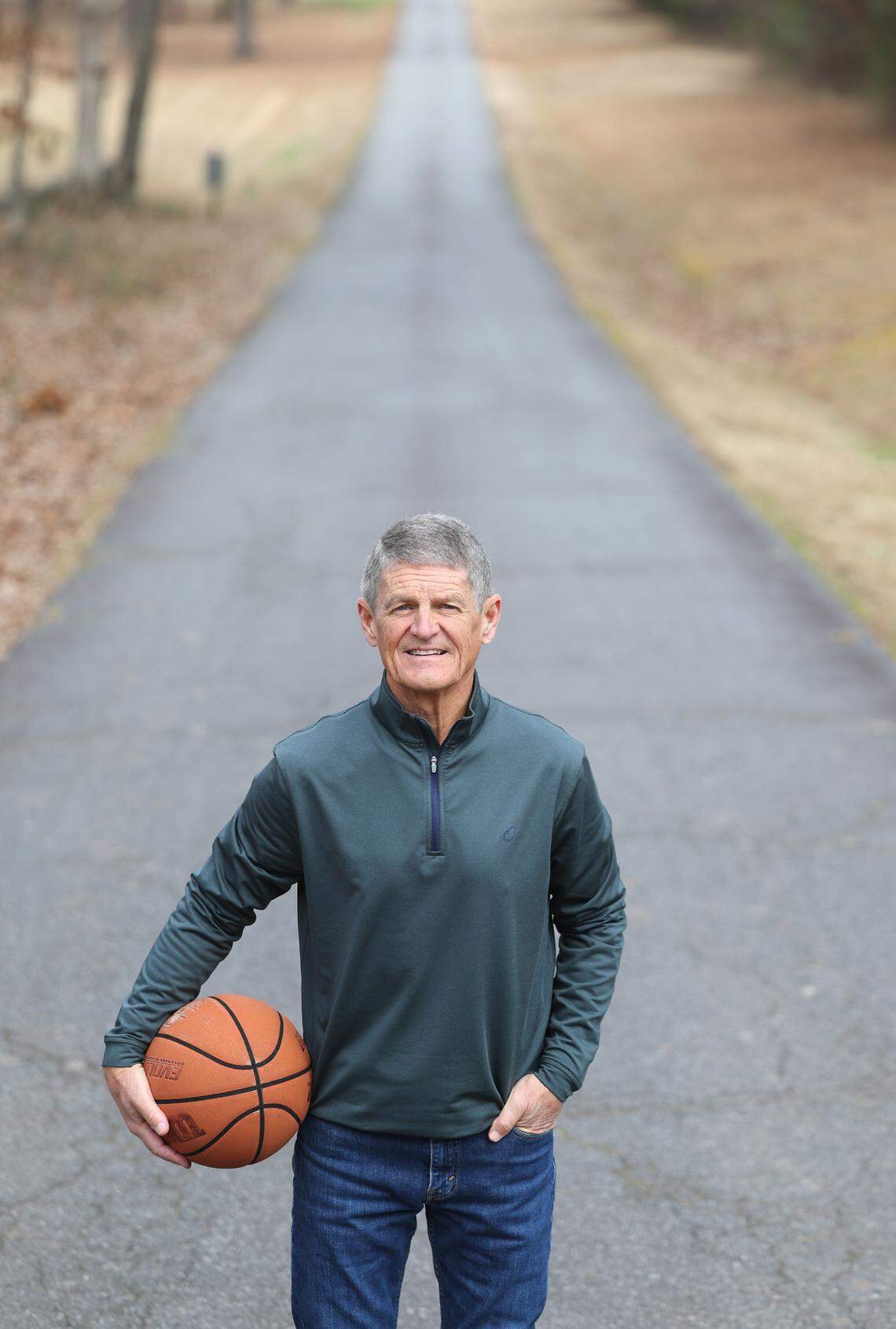 Former Charlotte 49ers head basketball coach Bobby Lutz, standing on a road in his hometown of Denver, N.C., will be honored by the school on Saturday.