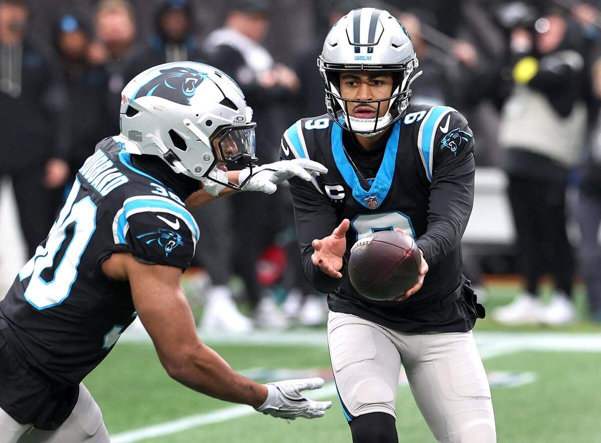 Carolina Panthers running back Chuba Hubbard, left, takes the handoff from quarterback Bryce Young, right, during Sunday’s action at Bank of America Stadium. Hubbard had 17 carries after getting only 15 carries combined over the previous four games.