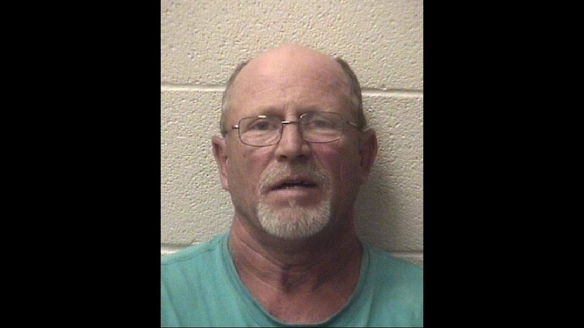 Michael Douglas Porter, 54, is accused of shooting a gun at firefighters who were responding to a grass fire Tuesday.