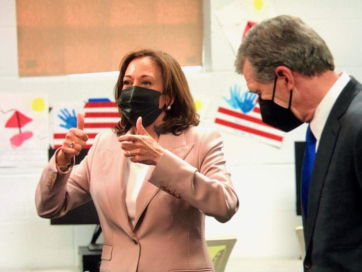 Vice President Kamala Harris, left, gives a thumbs up at Carole A. Hoefener Community Services Center in Charlotte as N.C. Gov. Roy Cooper looks on during her visit Thursday.