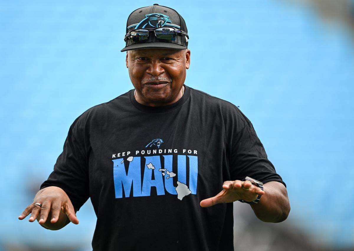 Carolina Panthers senior assistant coach Jim Caldwell talks with members of the Detroit Lions’ coaching staff during a preseason game at Bank of America Stadium on Aug. 25, 2023.